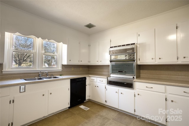 kitchen with dishwasher, light countertops, a sink, and white cabinetry