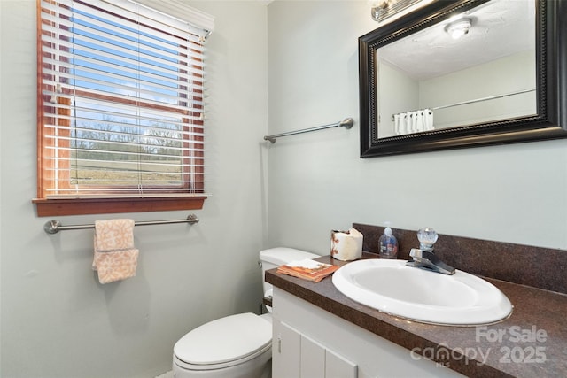 full bath featuring toilet and vanity