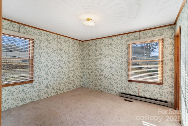 carpeted empty room featuring a baseboard heating unit, crown molding, and wallpapered walls