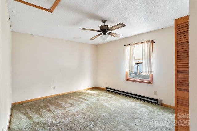 unfurnished room featuring carpet floors, baseboards, baseboard heating, and a textured ceiling