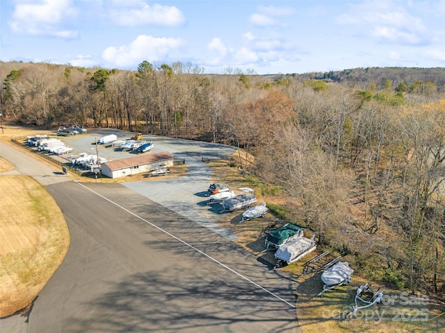 drone / aerial view with a wooded view