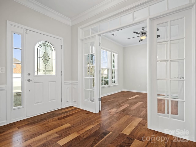 foyer entrance with dark wood-style floors, french doors, a wainscoted wall, crown molding, and a ceiling fan