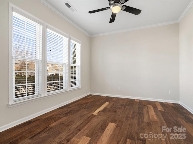 spare room featuring ornamental molding, dark wood-type flooring, visible vents, and baseboards