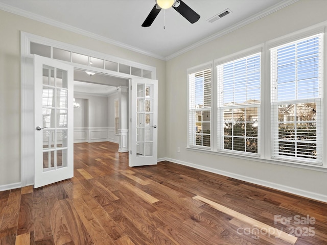 spare room featuring visible vents, ornamental molding, wood finished floors, french doors, and a healthy amount of sunlight