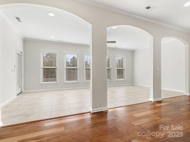 unfurnished room featuring recessed lighting, wood finished floors, visible vents, baseboards, and crown molding