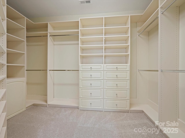 walk in closet with carpet floors and visible vents