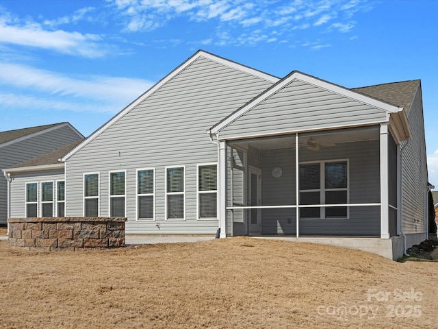 back of property with a sunroom and ceiling fan