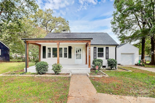 bungalow-style house with roof with shingles, an outbuilding, covered porch, a front lawn, and brick siding