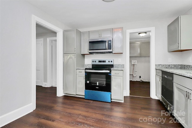 kitchen with dark wood-type flooring, baseboards, gray cabinets, light stone countertops, and black appliances