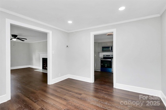 empty room featuring ornamental molding, a fireplace with flush hearth, dark wood-style flooring, and baseboards