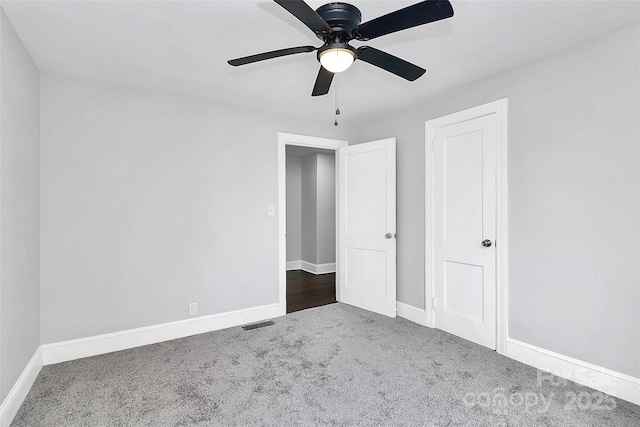 unfurnished bedroom featuring carpet, visible vents, and baseboards