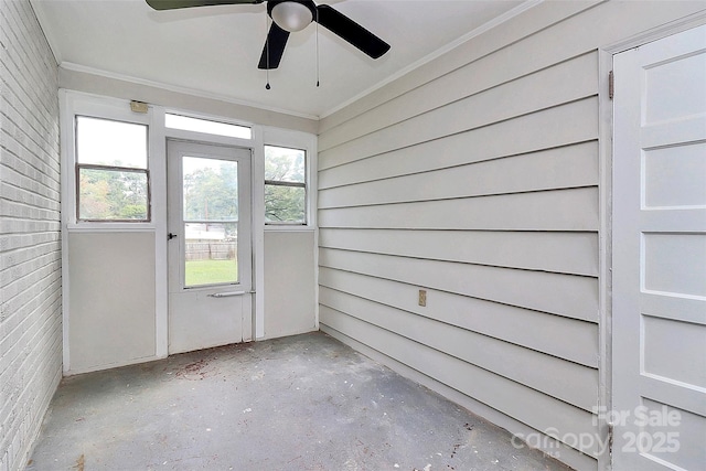 unfurnished sunroom with a ceiling fan