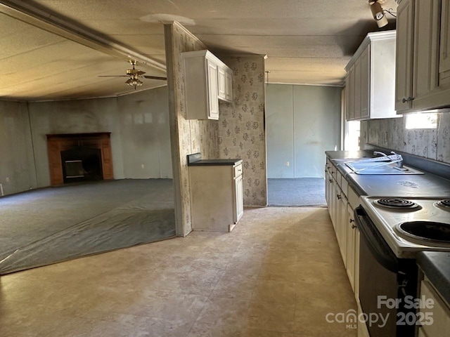 kitchen featuring open floor plan, electric stove, dark countertops, and a ceiling fan