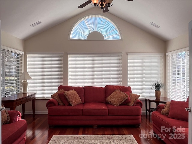 living area featuring ceiling fan, visible vents, vaulted ceiling, and wood finished floors