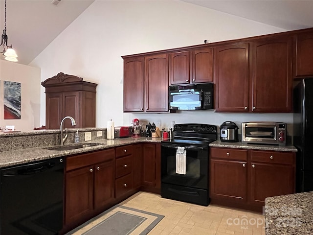 kitchen featuring lofted ceiling, dark stone counters, a sink, and black appliances