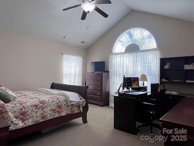 bedroom featuring ceiling fan, high vaulted ceiling, multiple windows, and light colored carpet