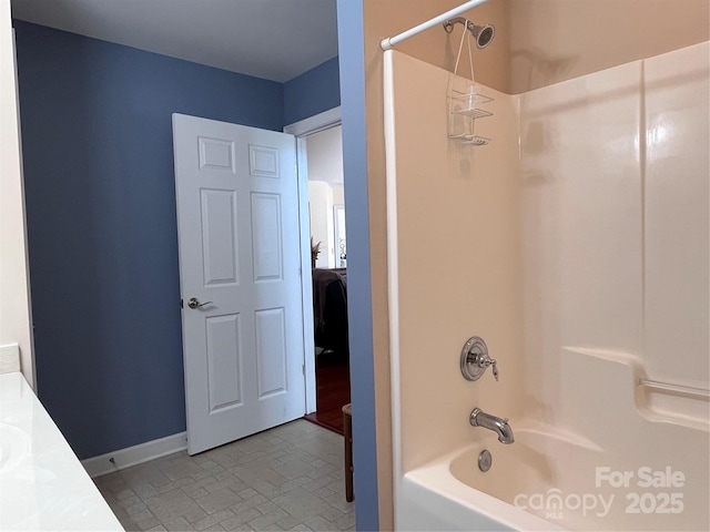 full bathroom featuring shower / bath combination and baseboards