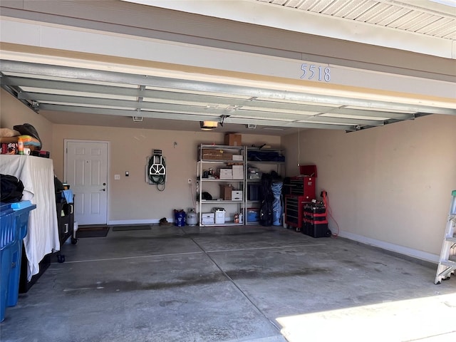 garage with baseboards and a garage door opener