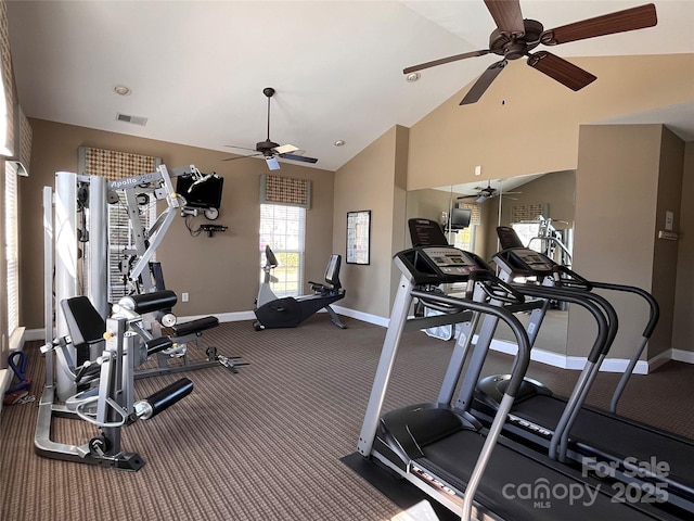 exercise room featuring high vaulted ceiling, visible vents, and baseboards