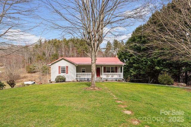 single story home featuring metal roof, a porch, and a front yard