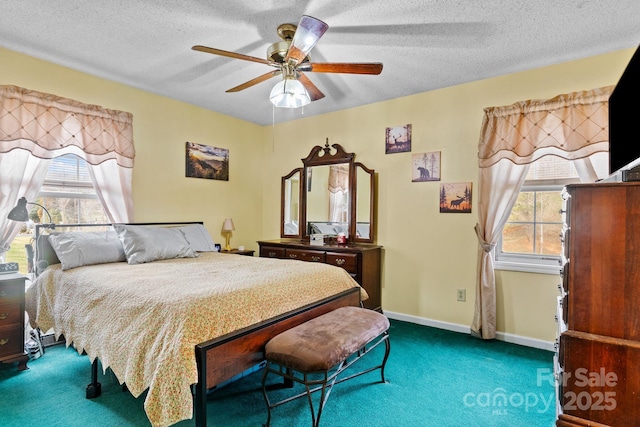 carpeted bedroom featuring multiple windows, ceiling fan, a textured ceiling, and baseboards