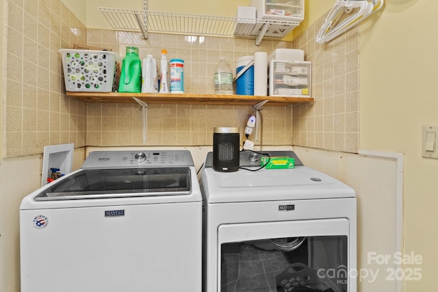 clothes washing area featuring laundry area and separate washer and dryer