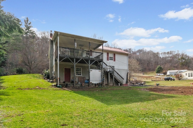 back of house featuring a wooden deck, stairs, and a yard