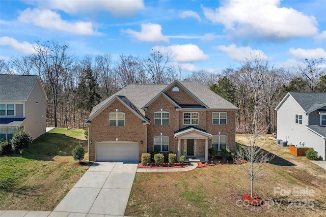 view of front of home with driveway, an attached garage, a front lawn, and brick siding