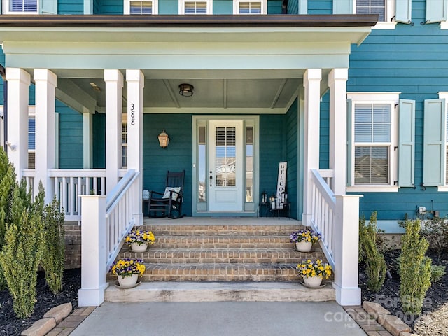 entrance to property featuring a porch