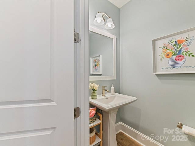 bathroom featuring baseboards and wood finished floors