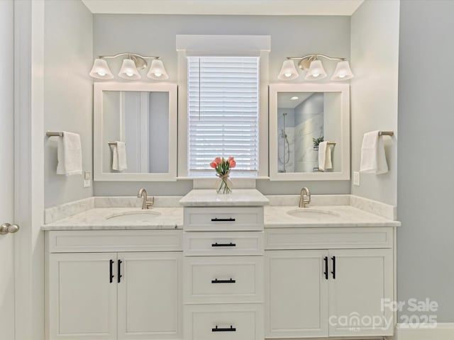 bathroom featuring a tile shower and vanity