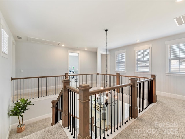 corridor with carpet floors, recessed lighting, visible vents, an upstairs landing, and baseboards