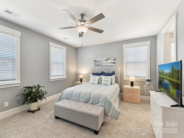 bedroom featuring baseboards, a ceiling fan, visible vents, and light colored carpet