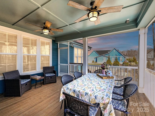 sunroom / solarium with a ceiling fan