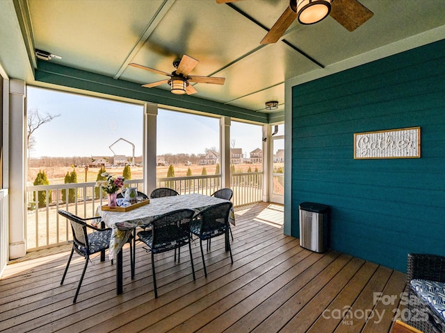 sunroom / solarium featuring a wealth of natural light and ceiling fan