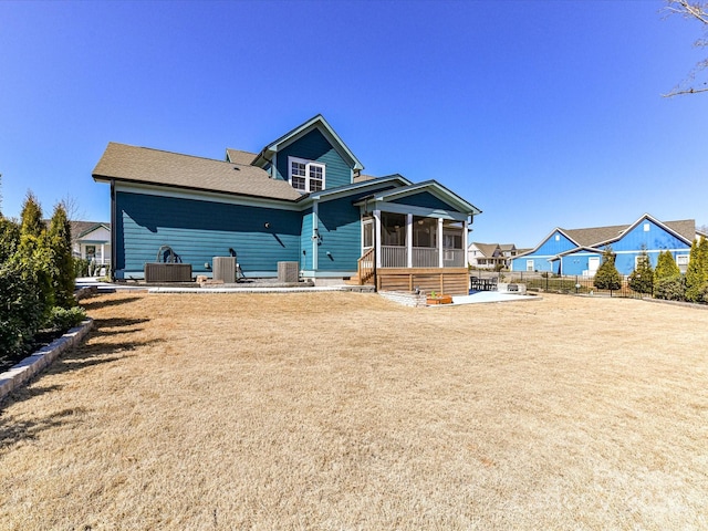 back of property featuring a sunroom and a patio area