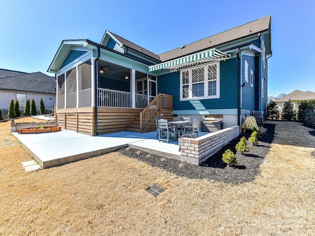 back of house featuring a sunroom and a patio area