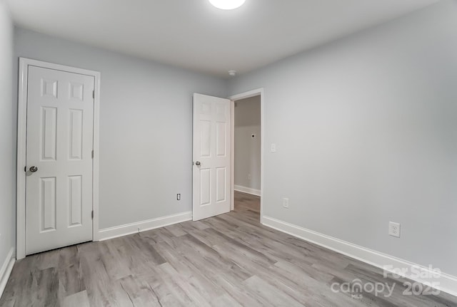 unfurnished bedroom featuring light wood finished floors and baseboards