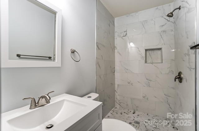 full bath featuring a stall shower, vanity, and toilet