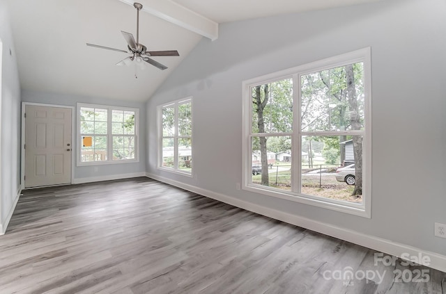 spare room with vaulted ceiling with beams, ceiling fan, baseboards, and wood finished floors