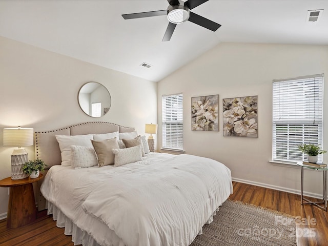 bedroom with visible vents, multiple windows, lofted ceiling, and wood finished floors