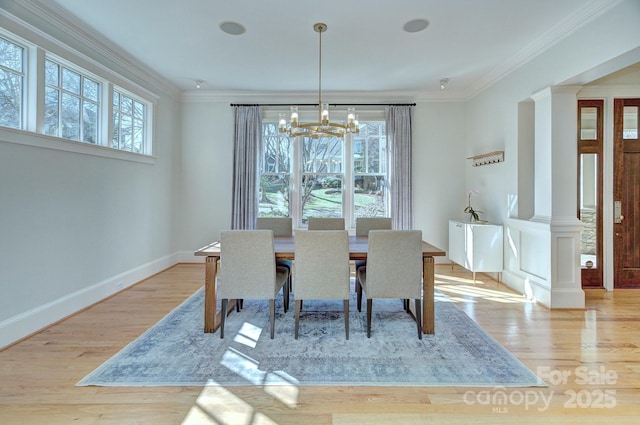 dining area with ornamental molding, plenty of natural light, and wood finished floors