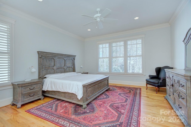 bedroom with light wood-style floors, multiple windows, and crown molding