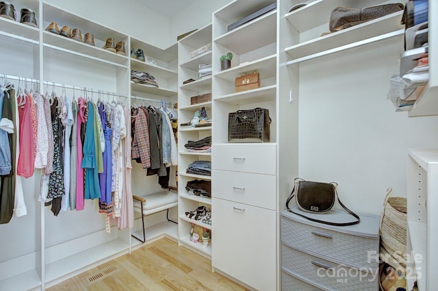 spacious closet featuring visible vents and wood finished floors