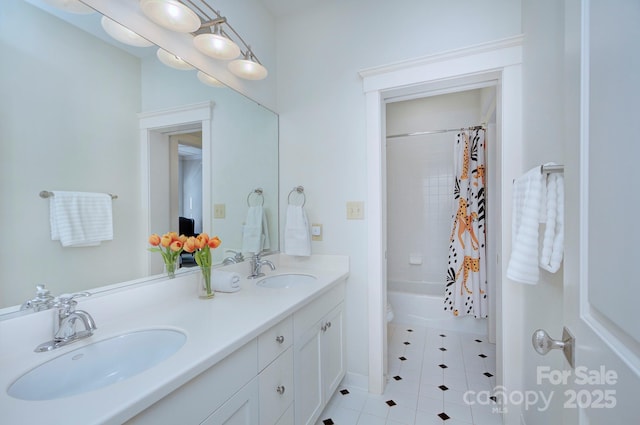 full bathroom featuring double vanity, tile patterned flooring, a sink, and shower / bath combo with shower curtain