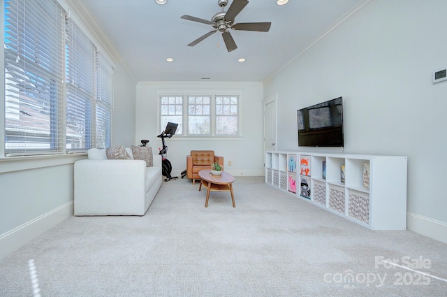 living area featuring ornamental molding, carpet, and a wealth of natural light