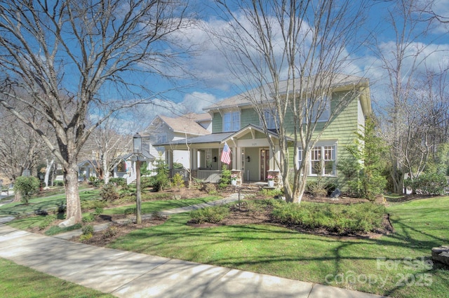 view of front facade featuring covered porch and a front yard