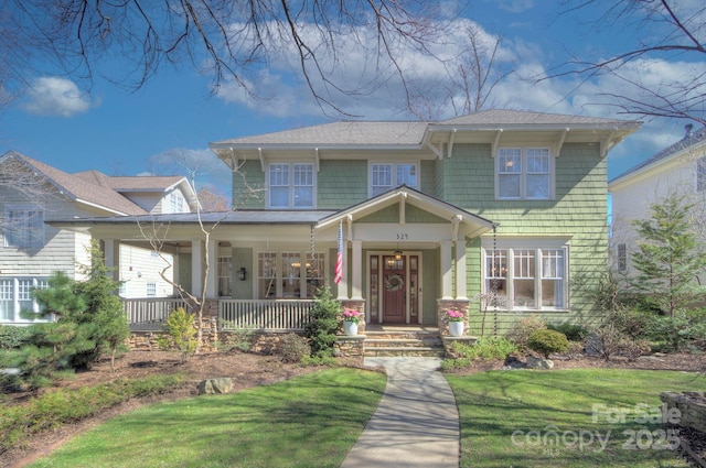 view of front of home with a front lawn and a porch