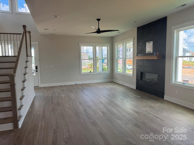 7459 Fighting Creek Rd Unit 33, Sherrills Ford, NC 28673 - unfurnished living room with a ceiling fan, wood finished floors, stairs, a tile fireplace, and healthy amount of natural light