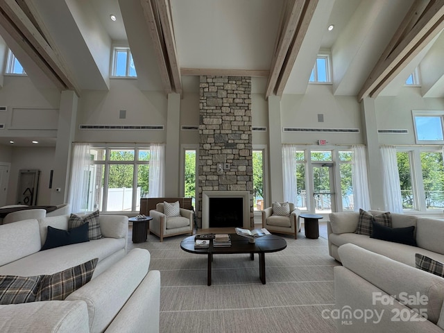 7459 Fighting Creek Rd Unit 33, Sherrills Ford, NC 28673 - living room featuring a towering ceiling, beamed ceiling, and a fireplace